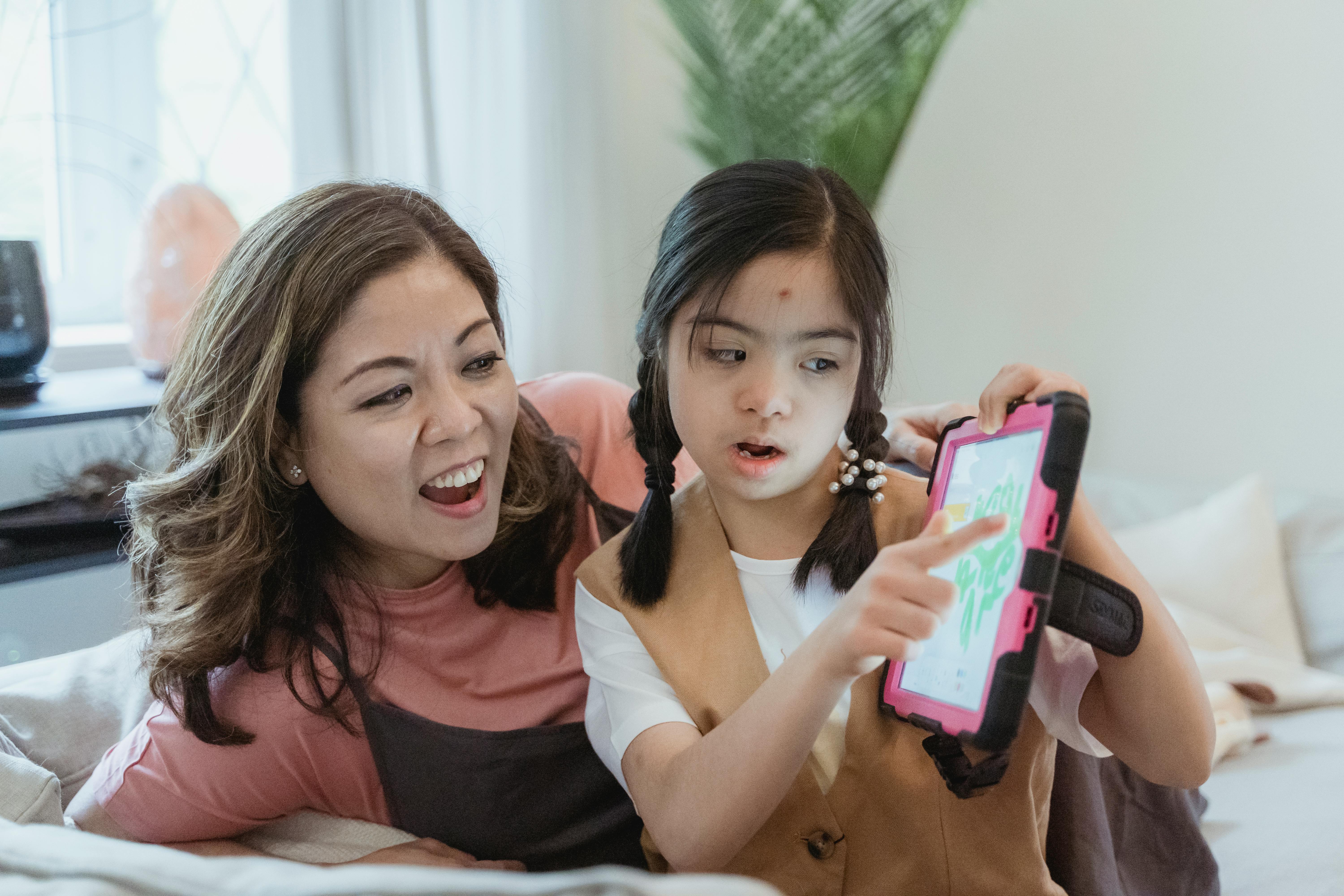 mother and daughter looking at an ipad