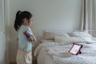 Young Girl looking at herself at an Ipad