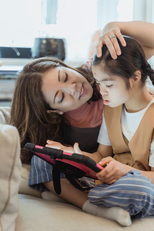 Free A mother and daughter enjoying quality time together using a digital tablet at home. Stock Photo