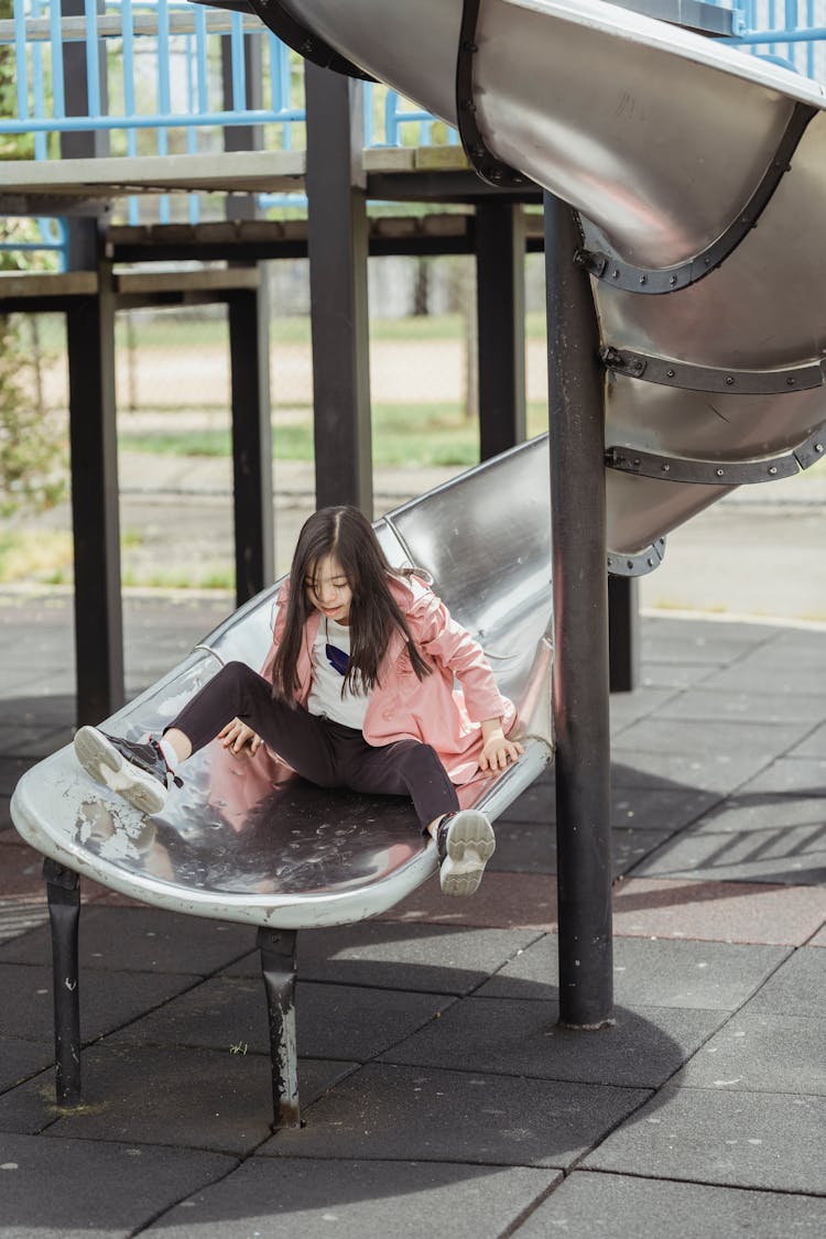 Girl On A Playground Slide 