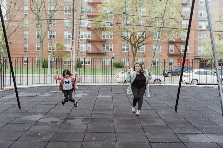 Mother And Daughter Playing A The Playground