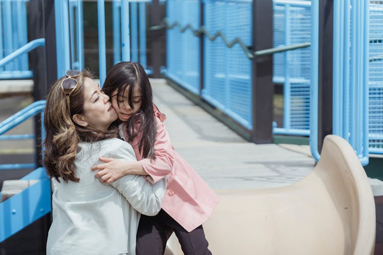 Mother And Daughter Playing A The Playground