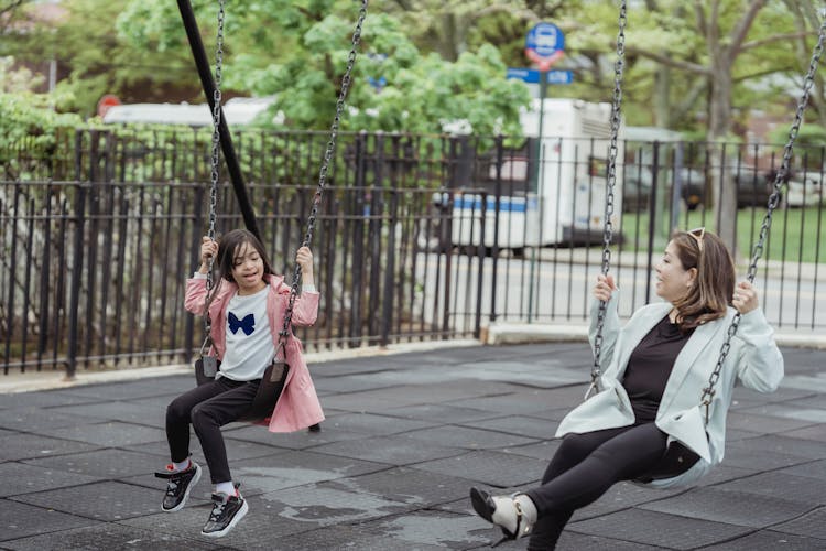 Mother And Daughter Playing A The Playground