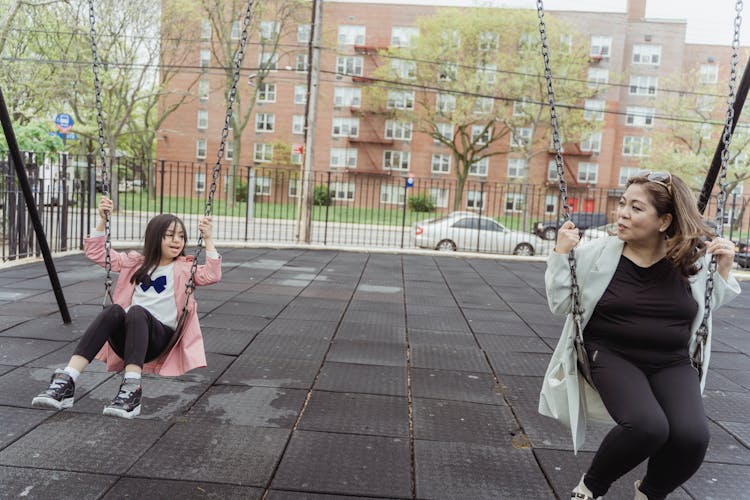 Mother And Daughter Playing A The Playground