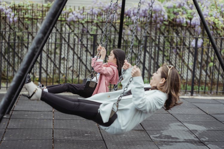 Mother And Daughter Playing A The Playground