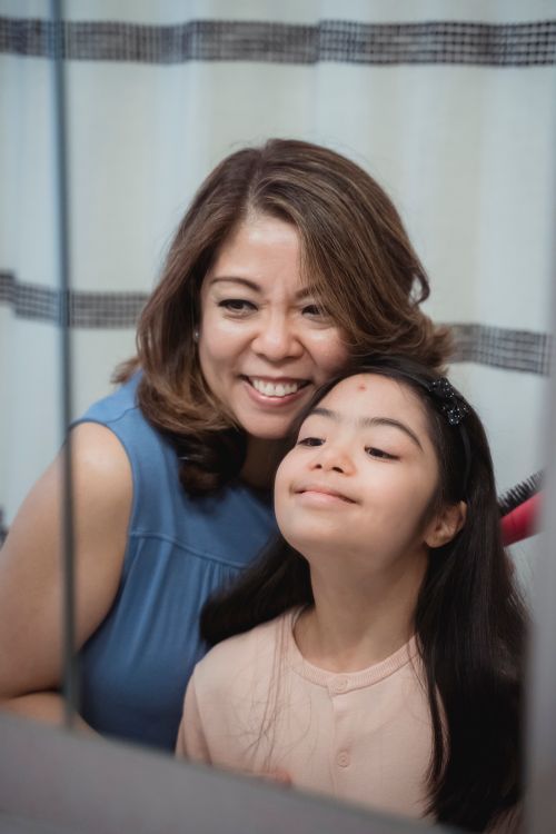 Free A joyful mother and daughter bonding moment captured indoors with warm smiles. Stock Photo