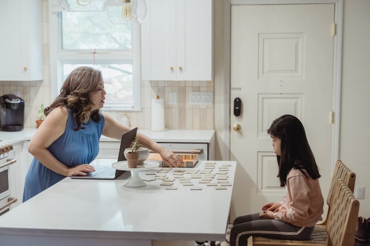 Little Girl Playing Memory Game With Mother