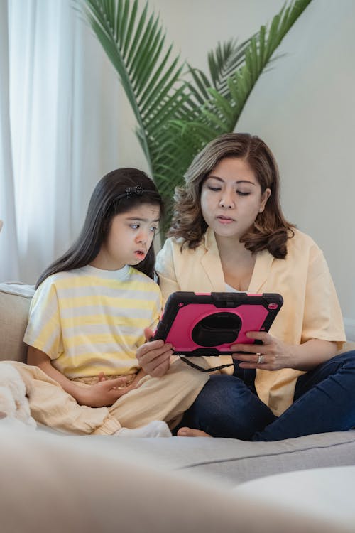 Mother and Daughter Looking at a Tablet