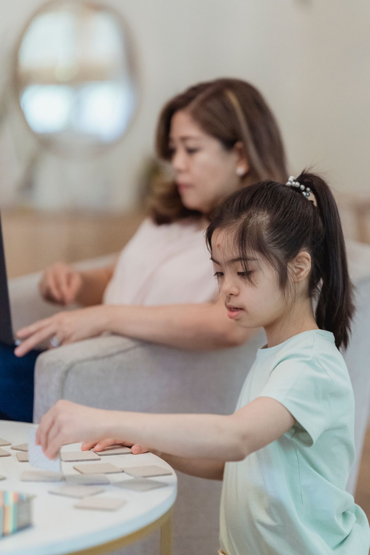 Young girl playing a board game at home