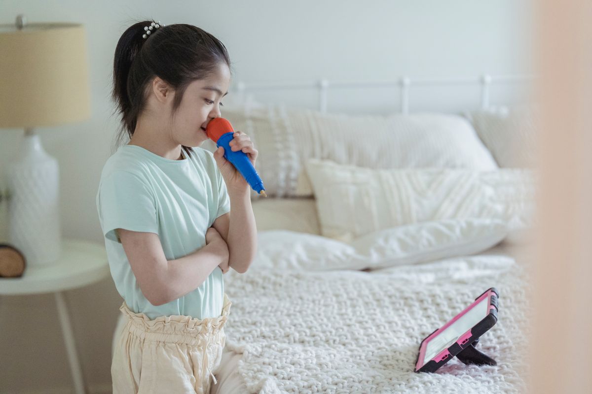 Young girl singing karaoke into a microphone