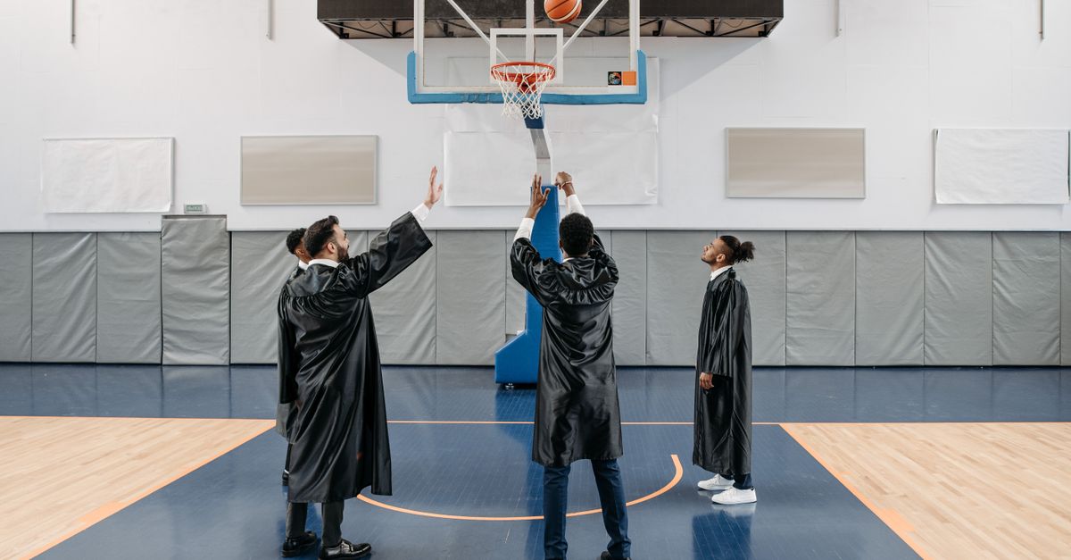 students playing basketball in a school gymnasium in Ho Chi Minh City with spectators cheering