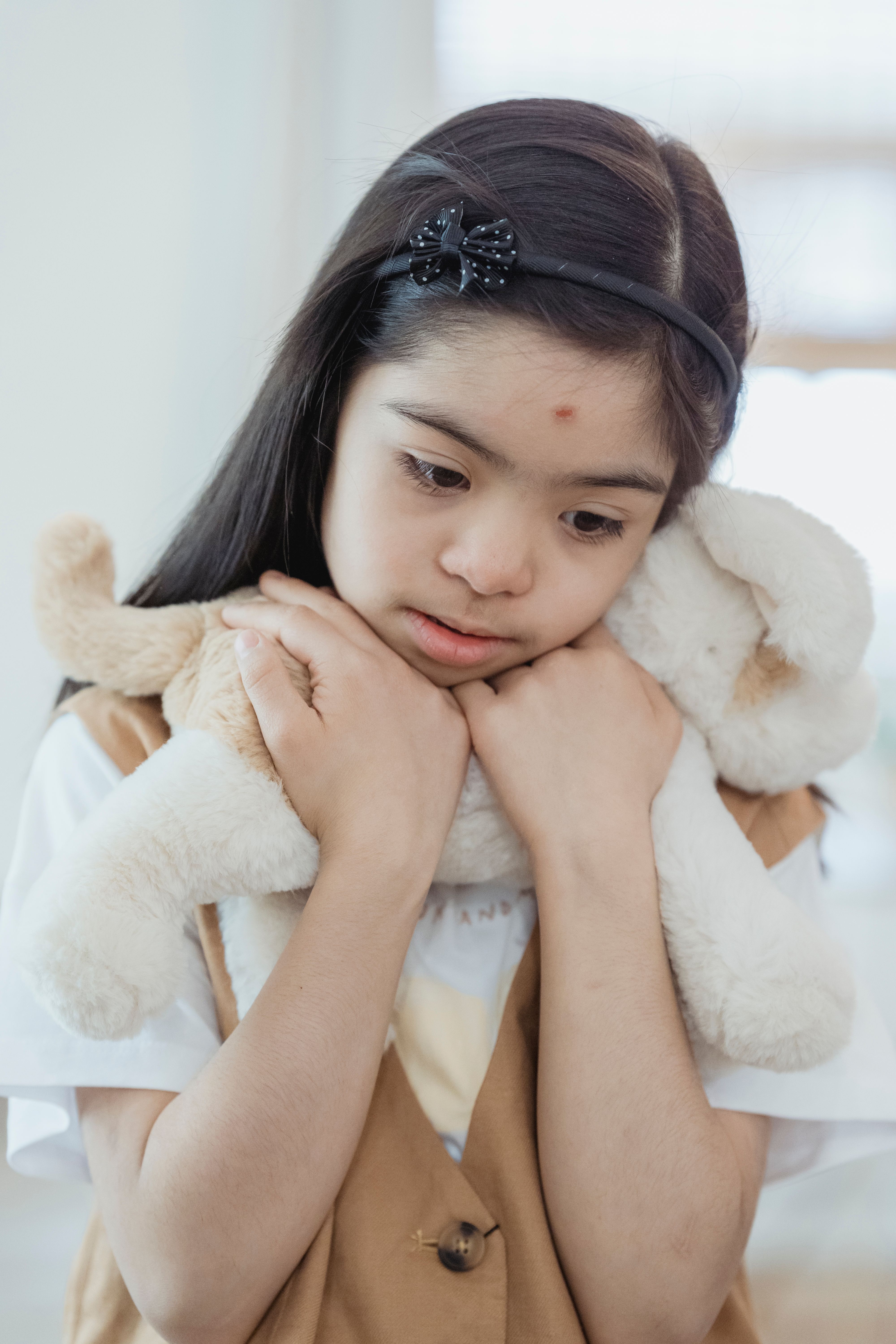 Portrait of a Girl Holding a Stuffed Toy · Free Stock Photo