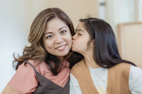 Portrait of a Daughter Kissing Her Mother