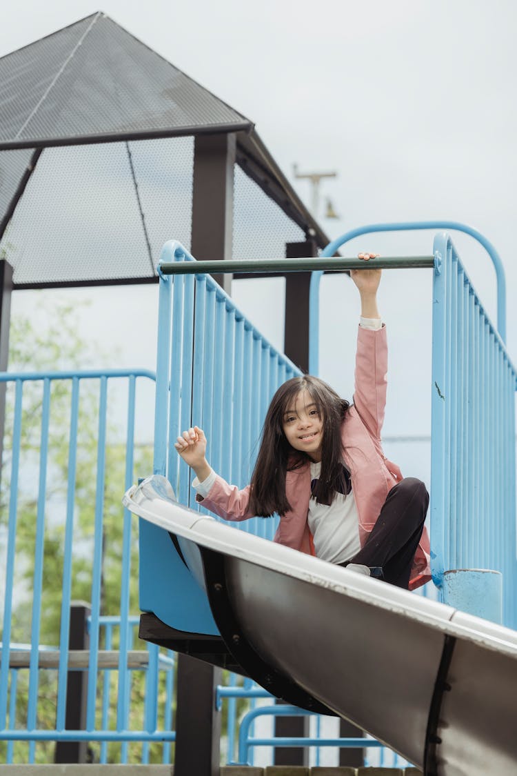 Photograph Of A Girl On A Slide