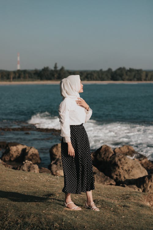 Woman with a White Hijab Near a Body of Water