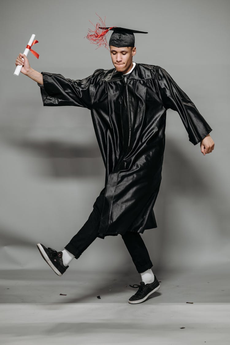 Photo Of Goofy Man In Black Graduation Gown 