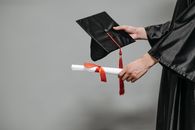 Photo of Person Holding Graduation Cap and Diploma