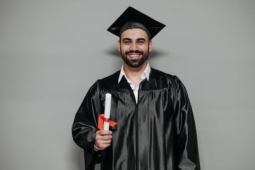 Happy bearded man in graduation attire, celebrating academic success.