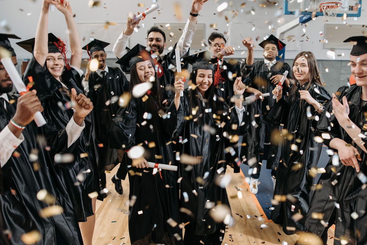 A person climbing steps toward a bright sky, symbolizing token graduation and milestone progression