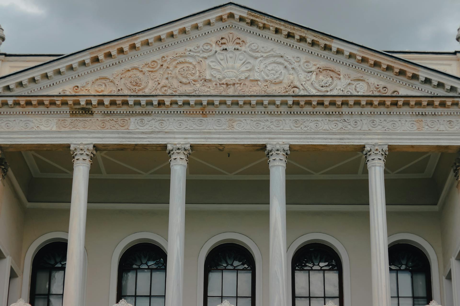 Ornate architectural facade featuring classical columns and detailed pediment.