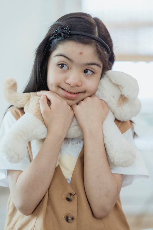 A Girl Holding a Stuffed Toy