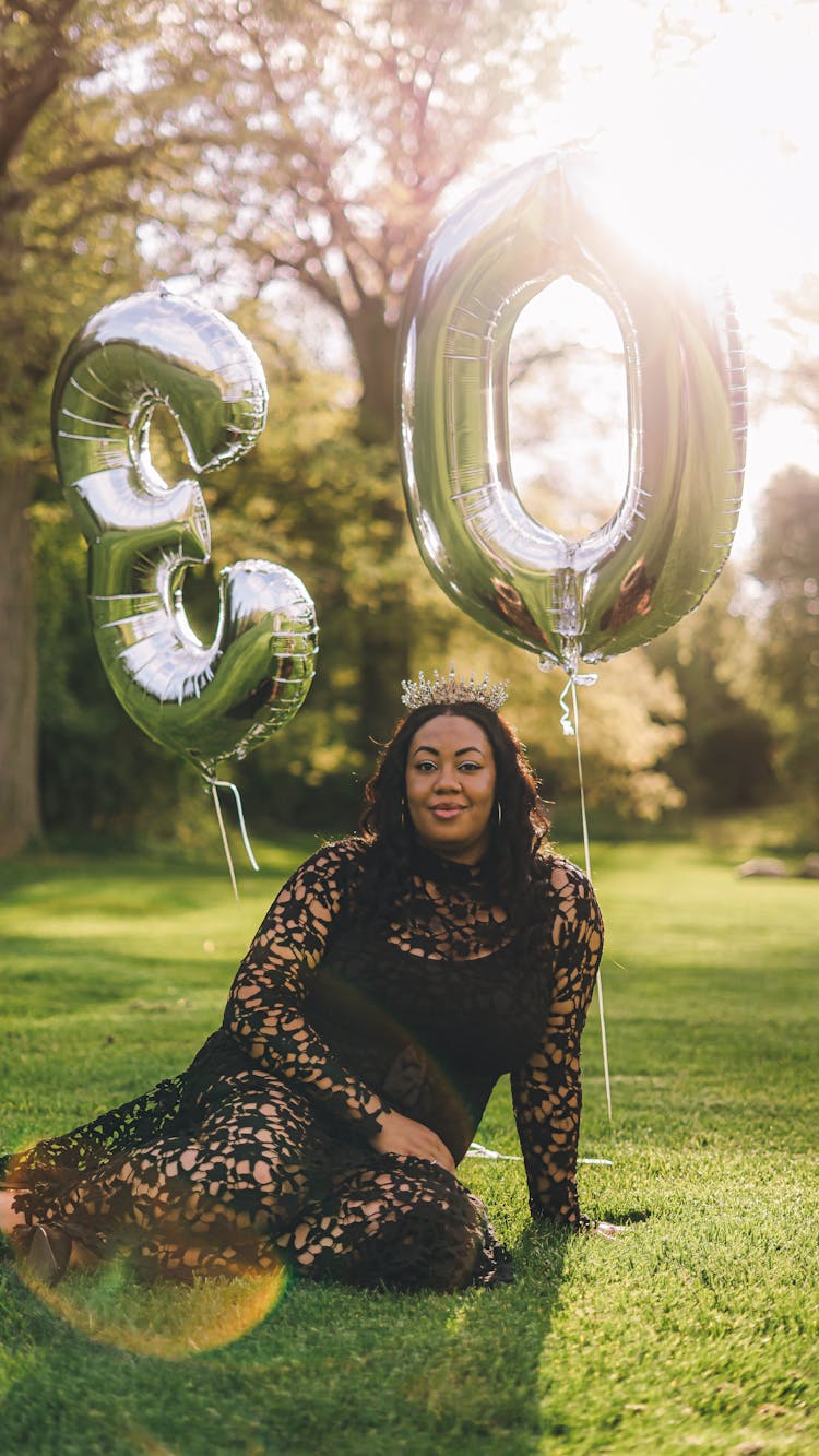 Black Woman With Balloons In Shape Of Number 30