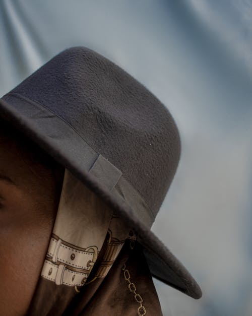 Close-Up Shot of a Person Wearing a Fedora Hat