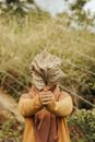 Person Holding Brown Dried Leaf Against Face