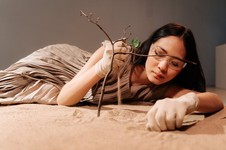 Woman Pouring Sand From Hand