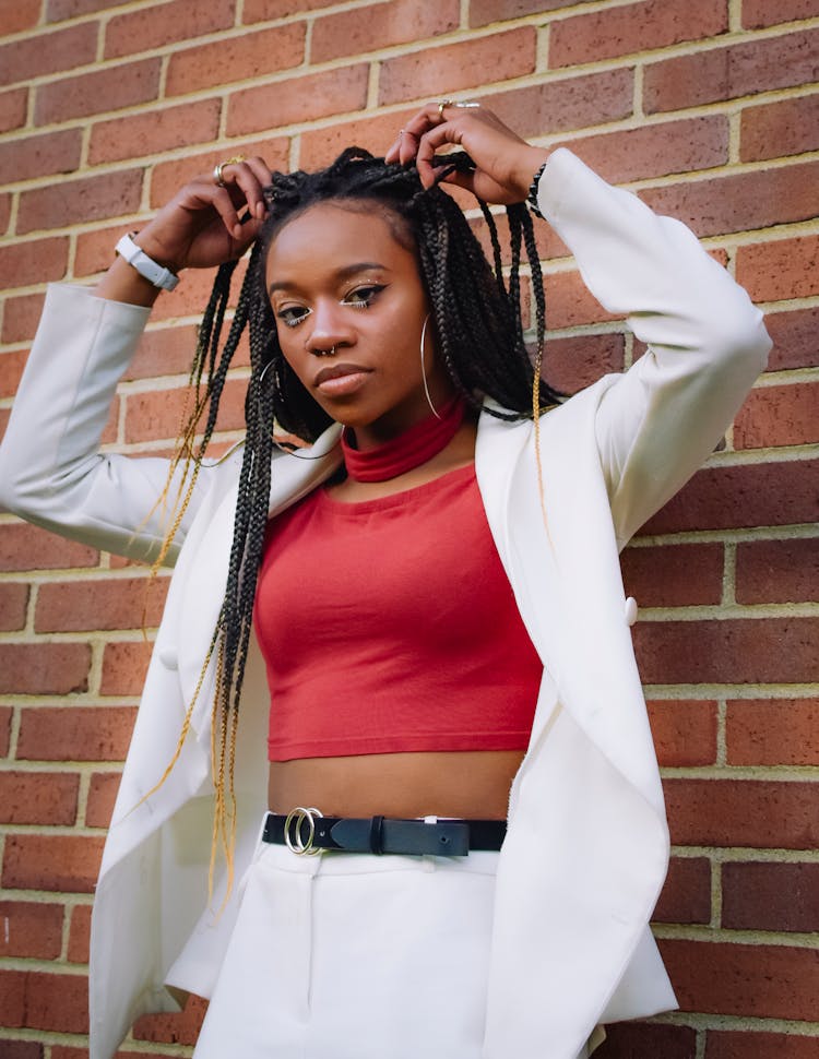 Woman In Red Crop Top And White Blazer 
