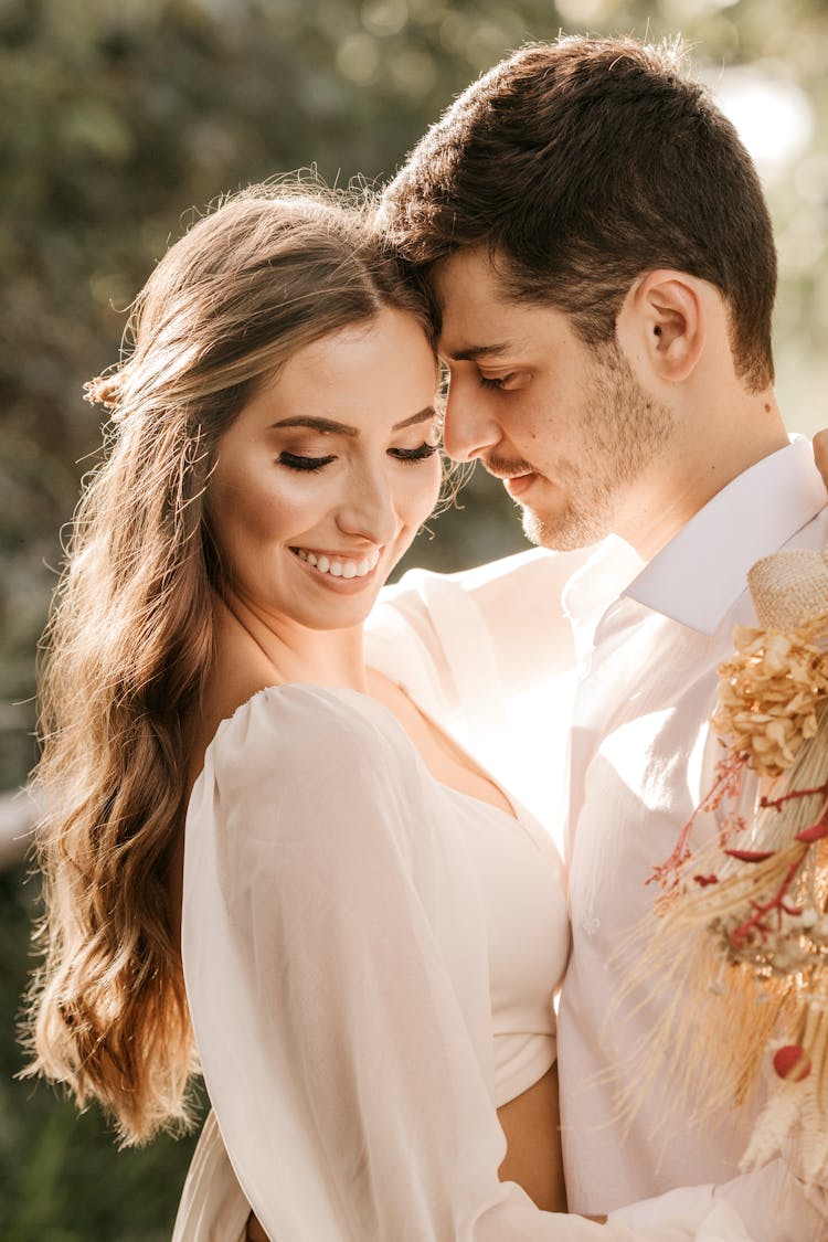 Happy Couple Hugging Outside In Daytime