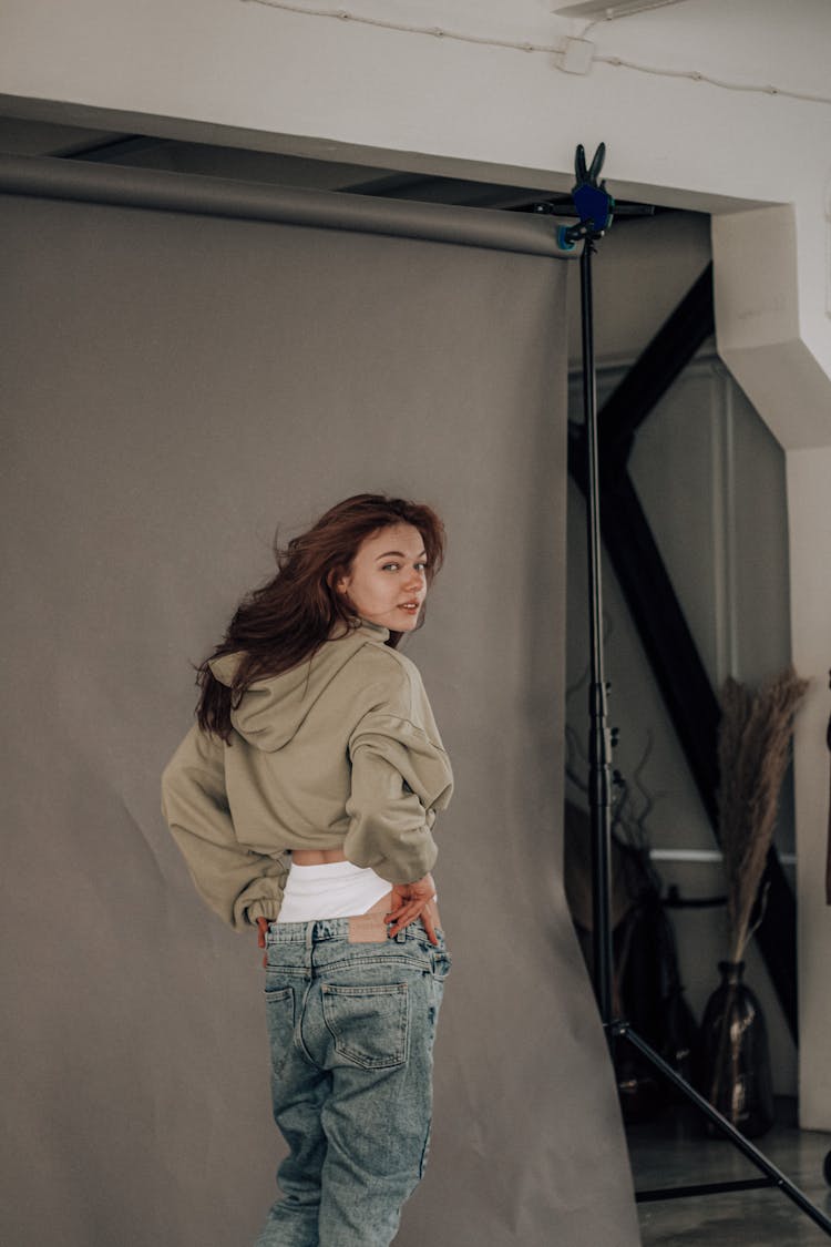 Woman In Stylish Outfit Looking Over Shoulder