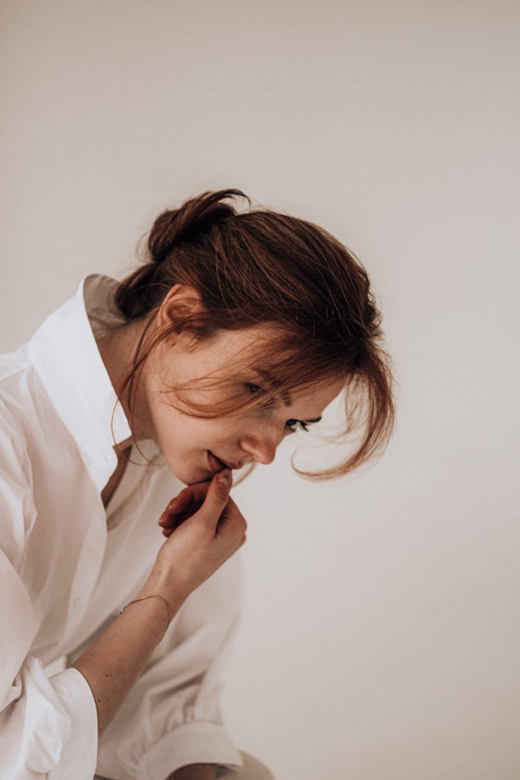 Thoughtful Young Female Thinking In Light Room