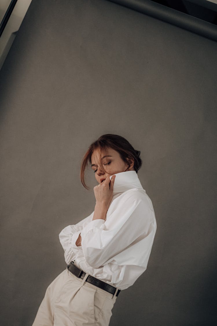 Confident Woman In White Shirt Standing With Closed Eyes