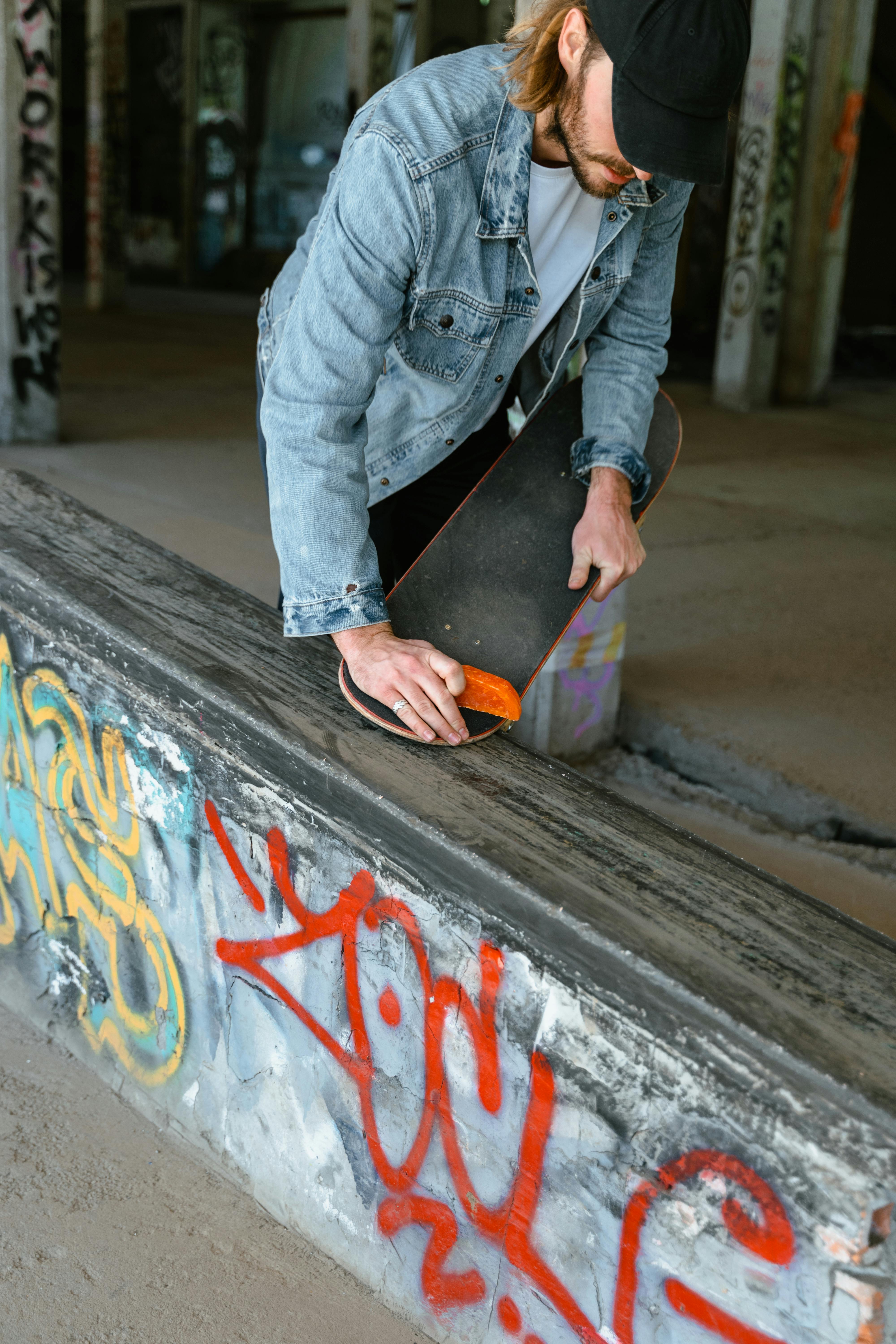 A Skater Waxing His Skateboard · Free Stock Photo