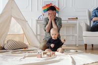 A Man Covering His Face with His Child