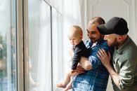 Man in Blue and White Plaid Button Up Shirt Carrying Baby in Blue and White Plaid