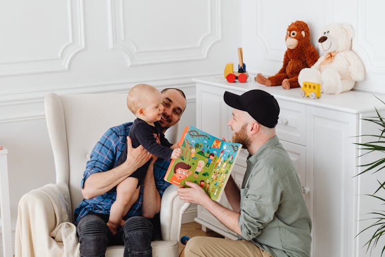 Two Men  Having Fun With A Baby