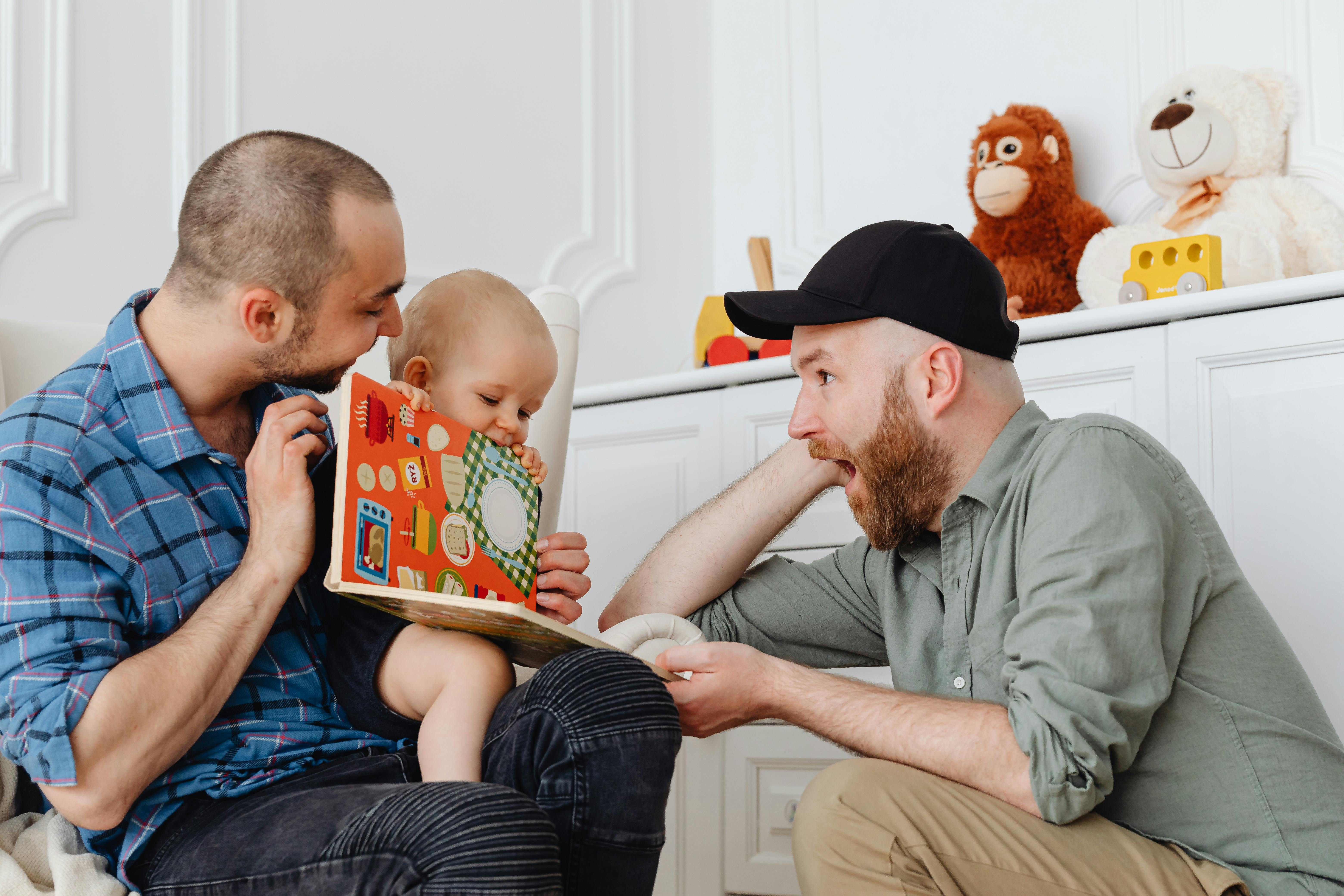 a same sex couple talking to their baby