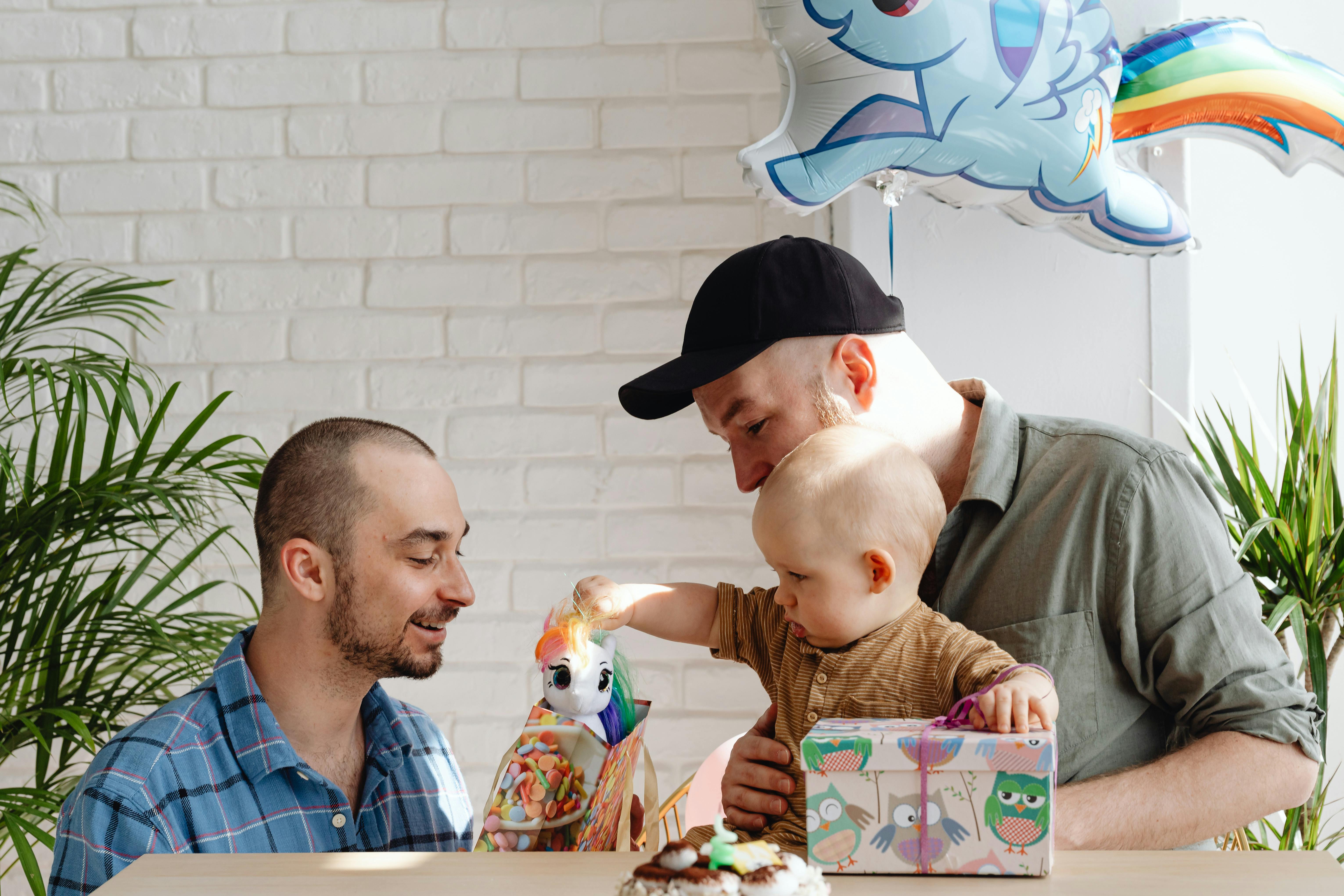 A Same Sex Couple Opening Gifts for Their Son · Free Stock Photo