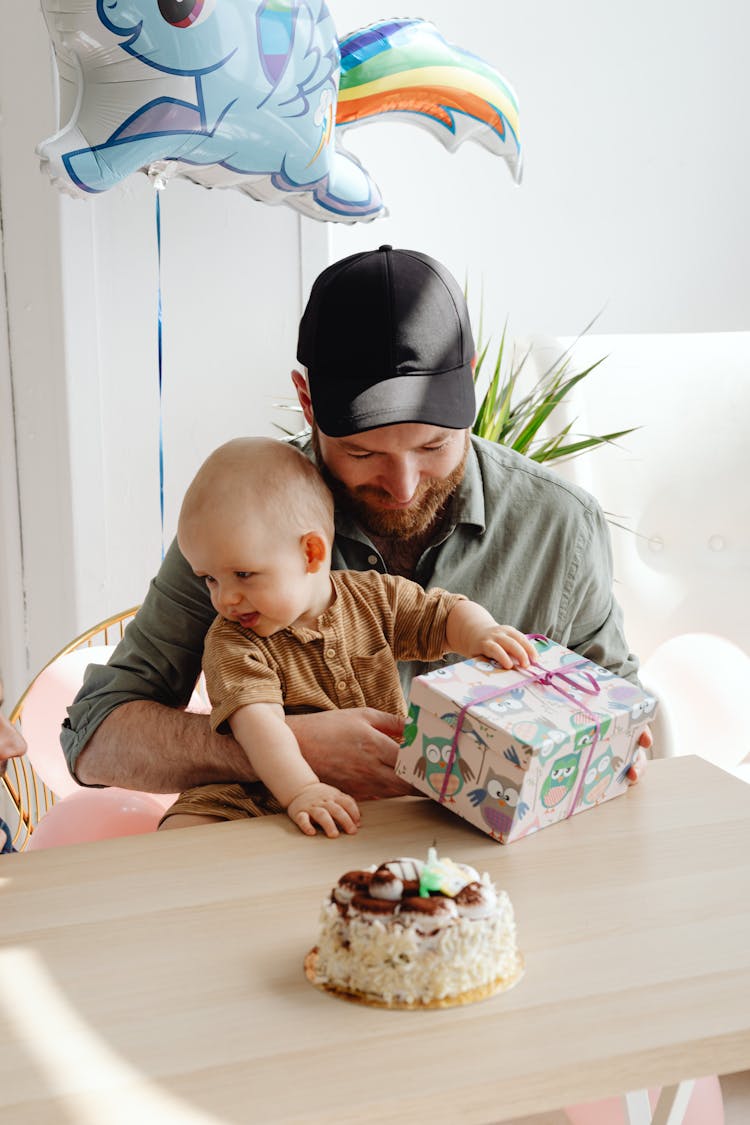 Father Giving Gift To Baby