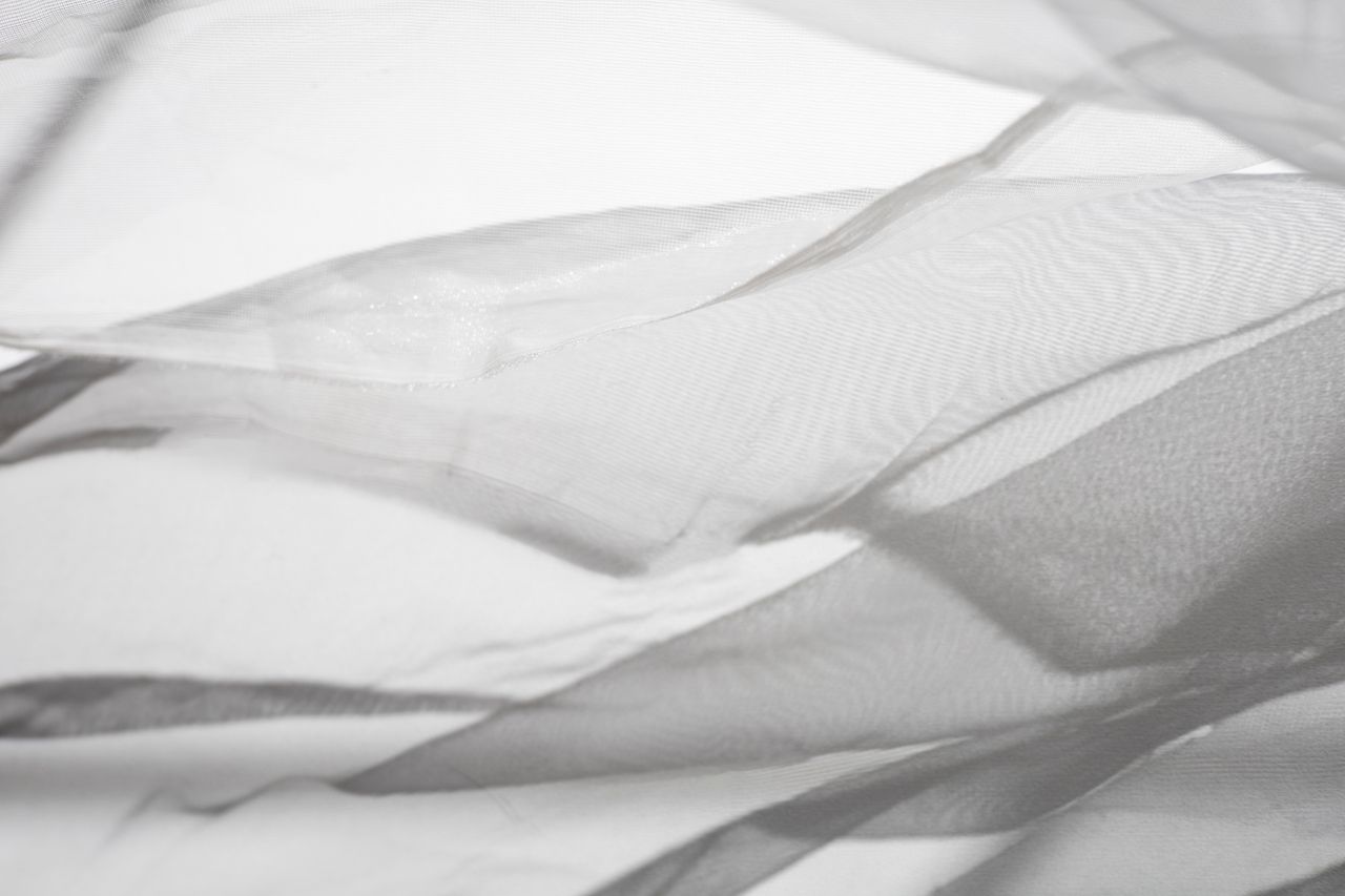 delicate overlay of sheer fabric in abstract grayscale composition