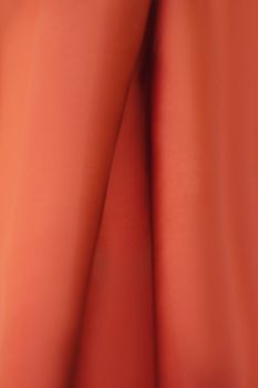 Detailed close-up of red textile showcasing natural fold marks and texture.