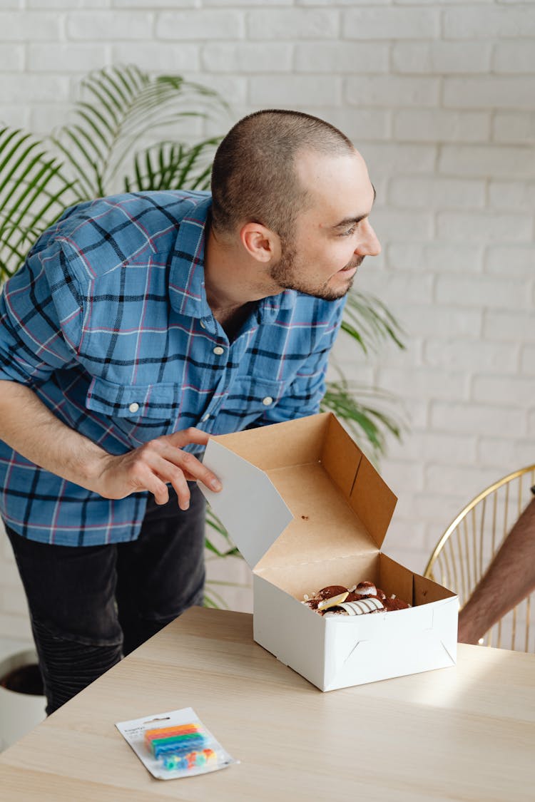 Man Holding A Box Of Cake