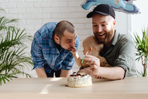 Free Men Celebrating a Child's Birthday Stock Photo