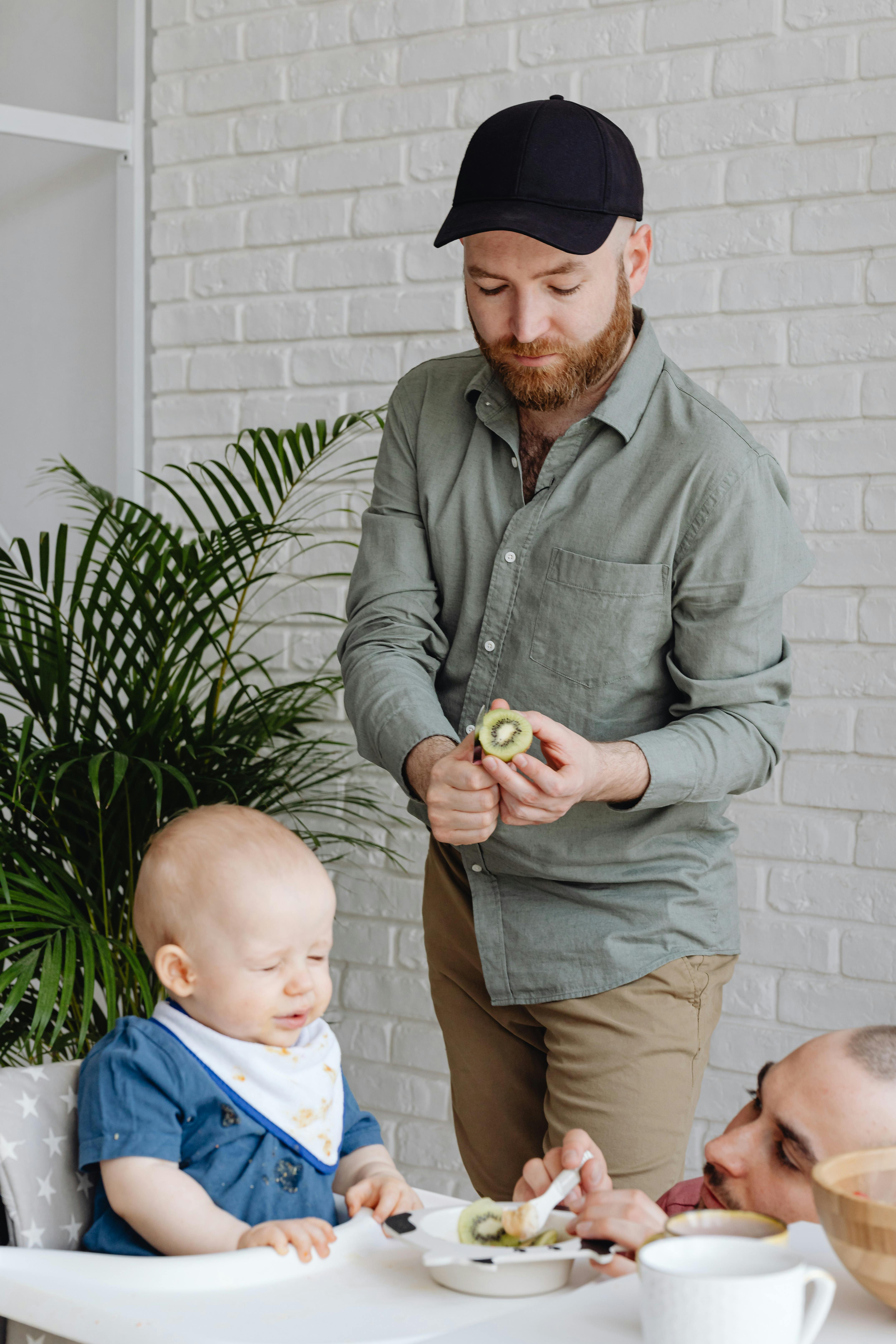 a man feeding a baby boy