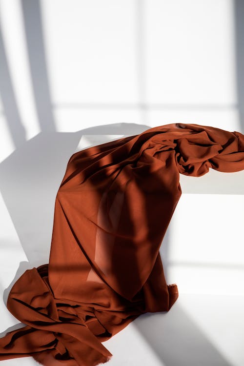 Close-Up Shot of Brown Textile on White Box