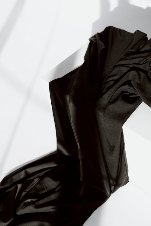 Close-Up Shot of Black Textile on White Box
