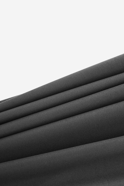 Folded charcoal technical fabric — photo by Hanna Pad on Pexels