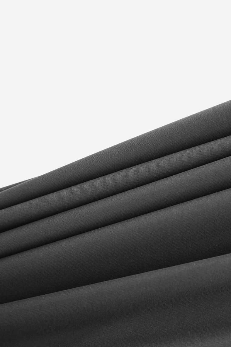 Close study of folded black cloth — photo by Hanna Pad on Pexels